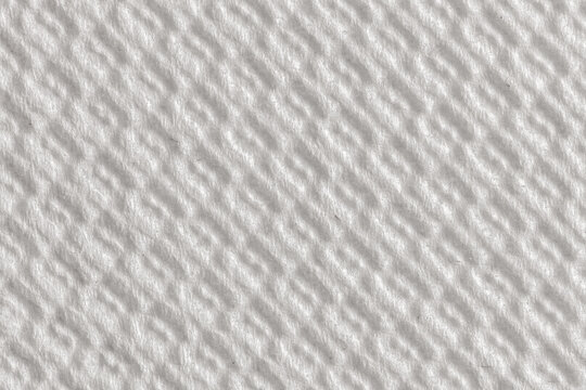 Extreme macro close-up of white paper towel or tissue surface with large deep circular dimple impressions. Strong shadow contrast highlights the 3D relief pattern on fibrous paper.