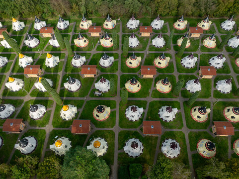 Slagharen, Netherlands - 03 October 2023: Aerial view of the Wigwam Parc's unique, spherical accommodations nestled amidst vibrant green lawns and bordered by lush, dark green trees.
