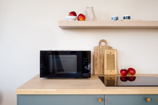 Modern minimalist kitchen with microwave and induction hob