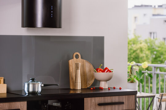 Modern kitchen with induction hob and electric stove in an apartment setting