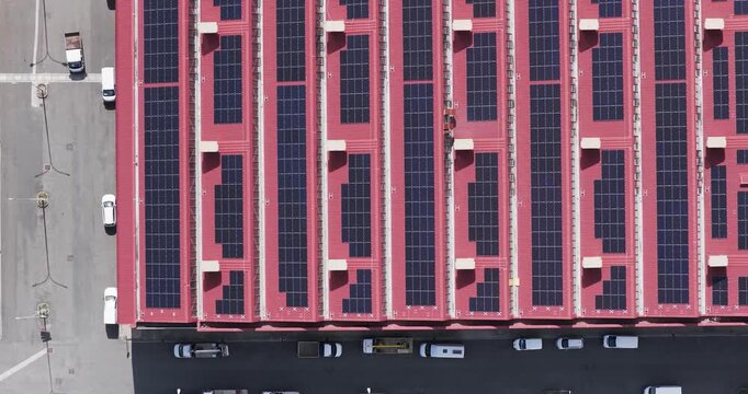 Larderello, Italy - 15 April 2026: Aerial view of Enel Green Power - Centrale Geotermica di Larderello with solar panels on a red roof and parked vans.