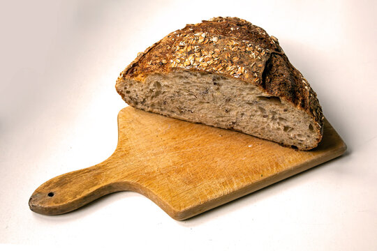 Healthy dark wheat wholemeal bread cut on wooden board