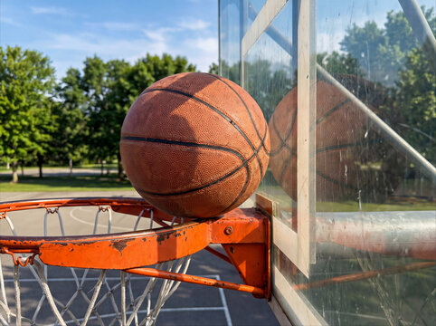 Basketball Stuck Against Backboard on Outdoor Hoop at Public Court