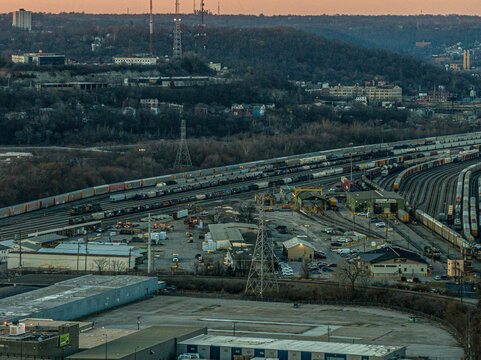 Cincinnati, United States - 27 February 2026: Aerial view of a sprawling railyard, a symphony of steel and shadow under the fading twilight, where lines converge and diverge.