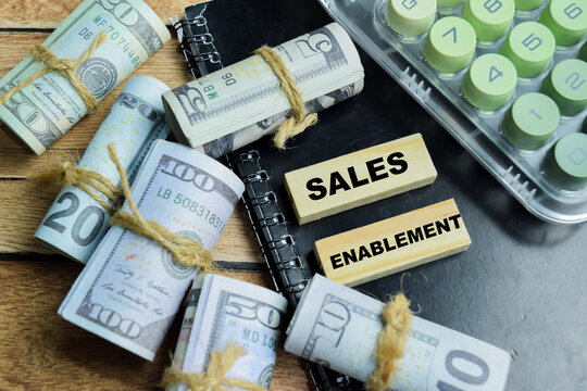 Concept of text sales enablement on wooden blocks. For business efficiency and revenue growth