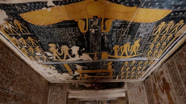 KV9 royal tomb of Ramesses, Valley of the Kings, Luxor, Egypt, covered with vivid hieroglyphics, winged deity, golden and blue astronomical symbols and divine figures.