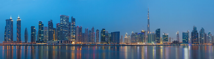 Fototapeta premium Dubai - The evening panorama over the new Canal with Downtown and Burj Khalifa tower.