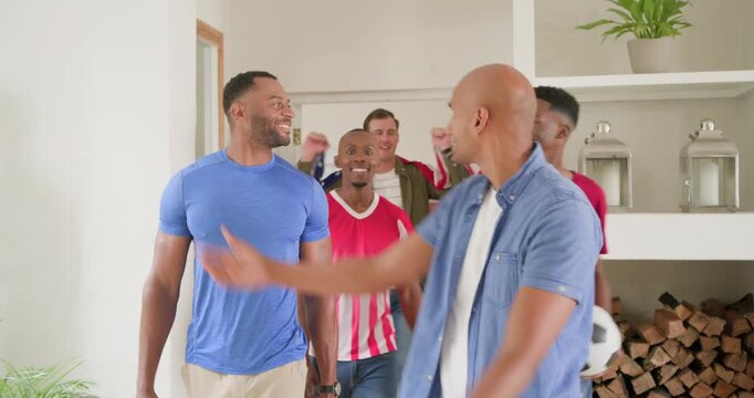 Diverse male friends entering doorway, shaking hands, unveiling American flag, celebrating together