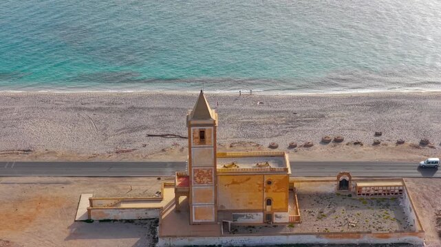 AERIAL - Church at beach, Cabo de Gata, Spain. Church of La Almadraba de Monteleva.