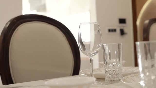 Cinematic video of a dining table with wine glass and other cutlery 