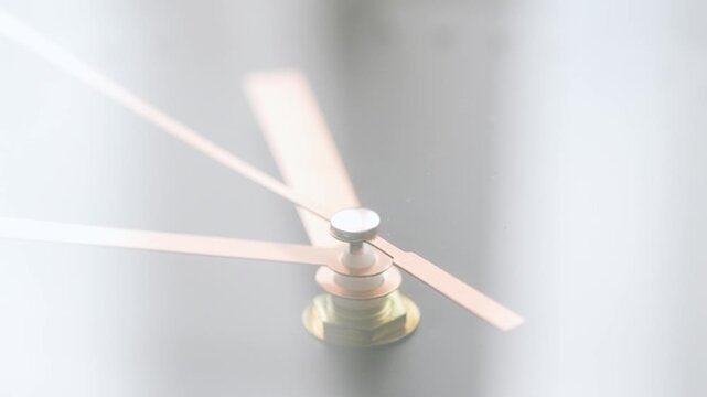 Golden second hand of a clock moving fast in a circle, time concept

