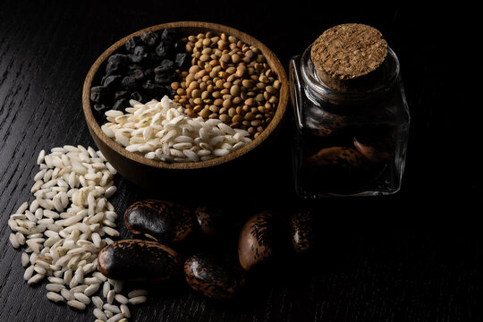 Still life of dried legumes such as lentils, devil's beans and black chickpeas with rice 02.26