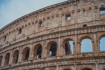Obraz premium Close-up of Ancient Roman Colosseum Arches with Travertine Texture and copy space