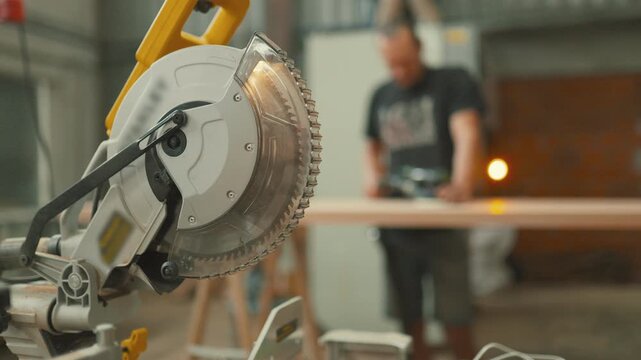Circular saw blade with carpenter working in background