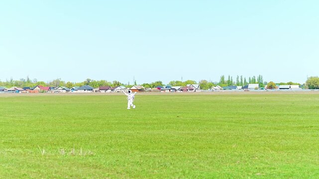 Astronaut in White Spacesuit Walking on Green Field at Air Show