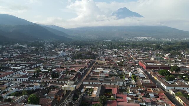 Hermosa vista desde Guatemala Antigua. Beautiful aerial footage of the colonial town of Antigua Guatemala. The Yellow arch clock of Santa Catalina Convent, Cathedral.