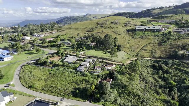 Drone flies south in the late afternoon over hills toward  main highway bypass around Mbabane, Eswatini