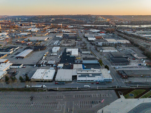 Aerial view of industrial buildings and parking lots stretching out towards the horizon, with the river snaking through the landscape, Cincinnati, USA.