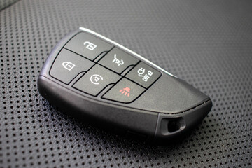 Obraz premium Automotive key with proximity sensor on textured surface.