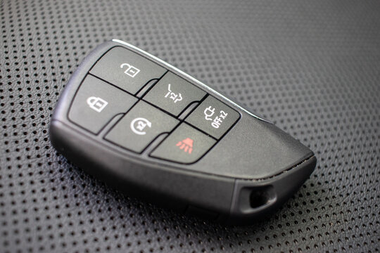 Automotive key with proximity sensor on textured surface.