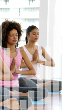 Vertical video: On start two women hands pressed doing yoga on blue mats while faint bars appearing