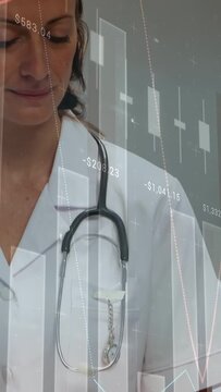 Vertical video: Pen touching blue clipboard, doc writing, glancing right, steth charts showing data