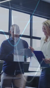 Vertical video: Man tapping tablet as woman pointing clipboard, IT animated waves guiding agreement
