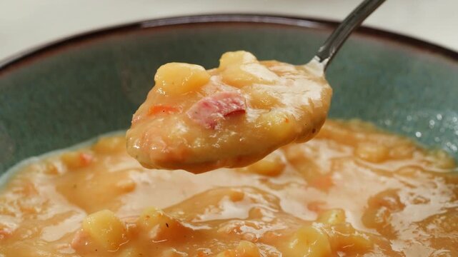 Split pea soup, Eating mashed pea soup with sausages and pork. Popular german or slavic food, winter street food.