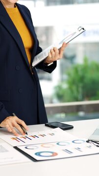 Business woman working in office checking documents.Accounting manager executive  reading paper file financial report, tax invoice.