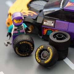 Naklejka premium Tambov, Russian Federation - January 17, 2026 Lego driver minifigure changing wheel of a Lego NASCAR Next Gen Chevrolet Camaro ZL car.