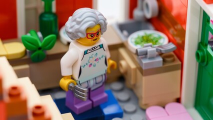 Naklejka premium Tambov, Russian Federation - January 27, 2026 Lego grandmother minifigure in his kitchen.