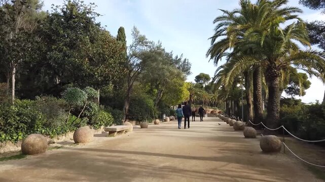 Walking Through Park Guell Barcelona POV. Walking through Park Guell in Barcelona. Iconic Gaudi park and major tourist attraction in Spain.