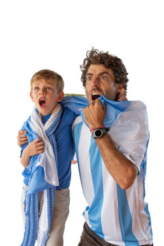 Father and son, fans of Argentine football, watching a match