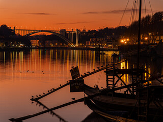 Porto cityscape at sunset with traditional rabelo boat © Paul