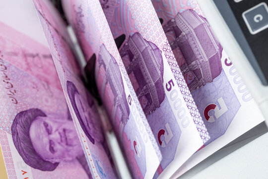 Iran money, Iranian rial machine counted. Business and financial concept. Close up