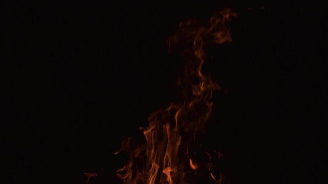 Fire slow motion flames filling darkness. Fire slow motion burning dynamic energy. Fire slow motion blazing vivid motion. Fire abstract design texture.