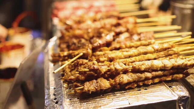 Korean barbecue, Ddakkochi, grilled chicken and pork skewers, variety of different traditional street food selection in Seoul, South Korea, night market with local vendor stalls cooking tasty dishes