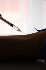 Naklejka premium Syringe preparing injection on arm with tourniquet