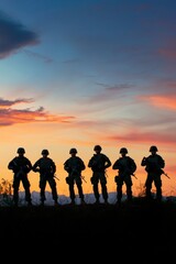 Fototapeta premium Six military figures stand on a ridge during sunset showcasing a moment of watchfulness and preparation