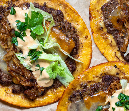 Top down close up look at delicious smash burger tacos with all the fillings.