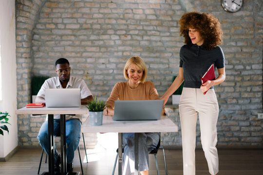 Team working together in modern office with laptops