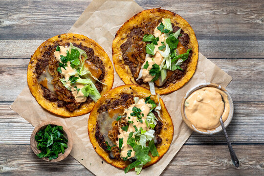 Above view of delicious smash burger tacos with fresh toppings.