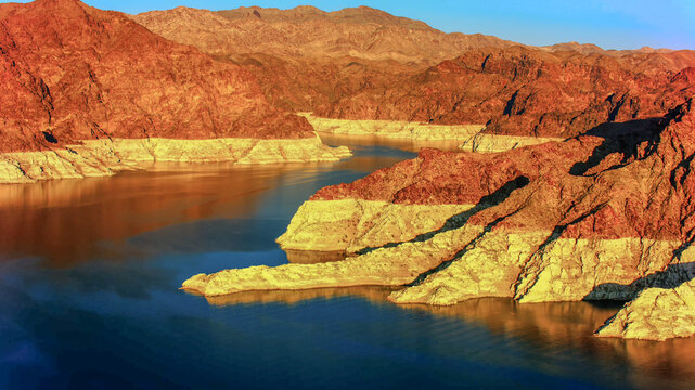 alm river winding through rugged red and golden mountains