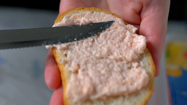 Spreading Pink Seafood Pate on Toast, Macro Shot of Healthy Fish Roe Breakfast, Culinary Preparation of Simple Snack