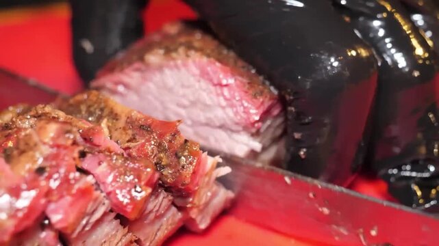 close-up shot of a chef's hands in black gloves using a sharp knife to slice into a perfectly cooked, juicy, and tender Texas BBQ brisket, revealing the pink smoke ring and rich texture on a bright re