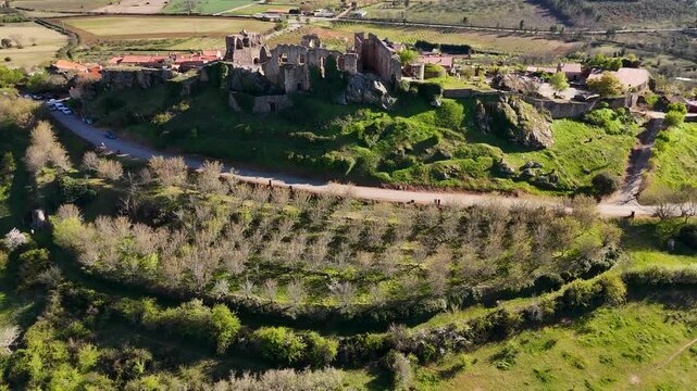 Aerial view flying away from trevejo castle ruins in spain