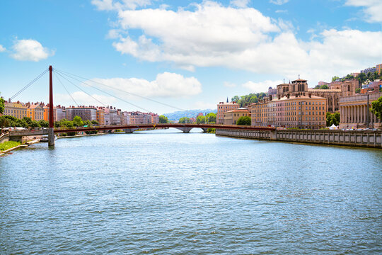 The Sa&ocirc;ne River in Lyon, red mast of the Passerelle du Palais de Justice on the left. The skyline of Vieux Lyon dominates the right bank, with the columns of the Palais de Justice