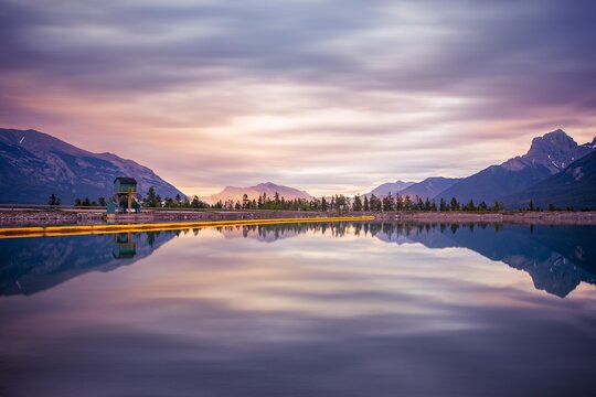 View into land of Mountain reflections in a Reservoir at dawn, Canada