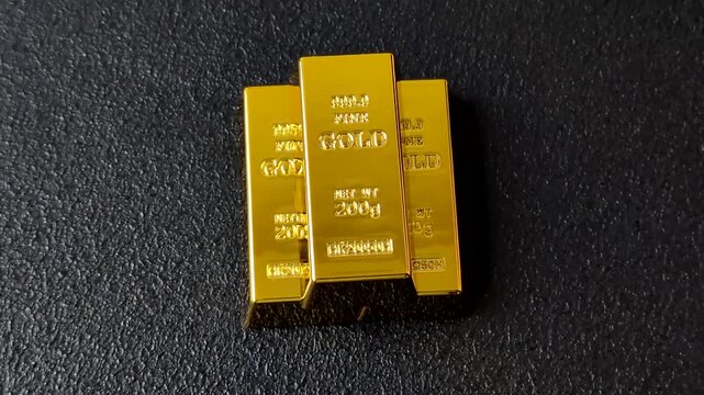 Gold bars or ingots as a metal for bank storage, investments, and financial transactions. Gold bars as a background for your design