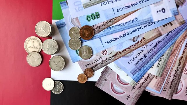 United Arab Emirates cash, paper dirhams, and coins for exchange and financial transactions. UAE currency as a background for your design